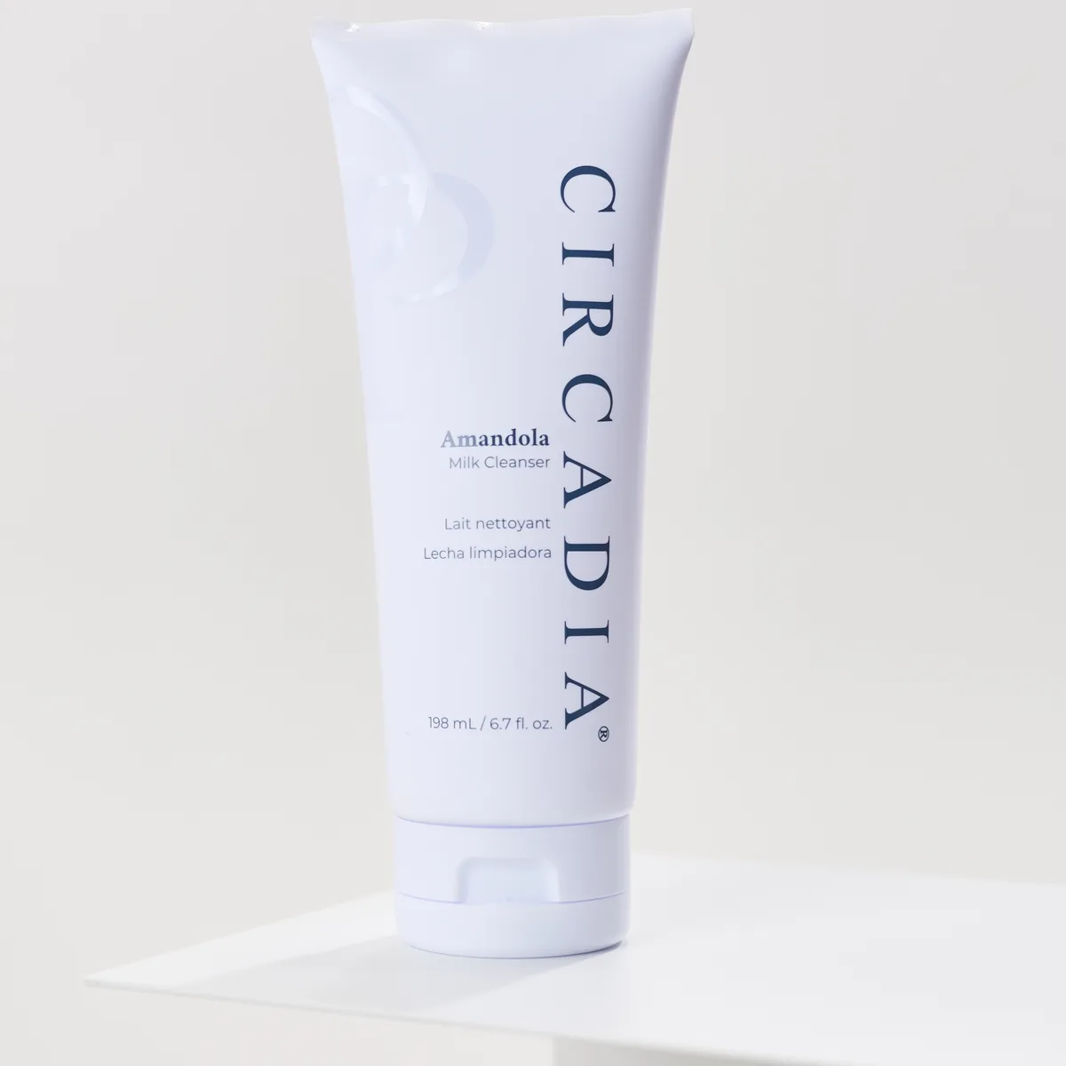 Amandola Milk Cleanser by Circadia, on a white pedestal