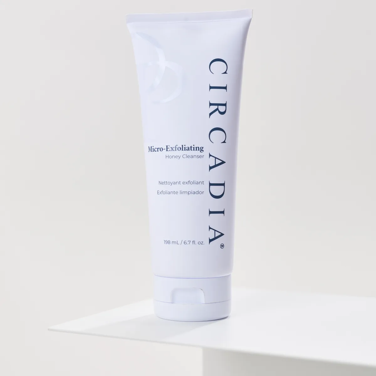 Micro-Exfoliating Honey Cleanser by Circadia, on a white pedestal